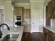 Kitchen features stainless steel appliances and hardware, and a contrasting backsplash at 165 Cotton Fields Ln # 25, Fuquay Varina, NC 27526
