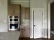 Well-equipped kitchen with stainless steel double ovens and ample cabinet space for storage and organization at 165 Cotton Fields Ln # 25, Fuquay Varina, NC 27526