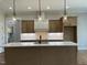 A sleek kitchen showcasing a large island, pendant lighting, and modern appliances at 165 Cotton Fields Ln # 25, Fuquay Varina, NC 27526