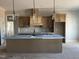 Close-up of the kitchen featuring wooden cabinets, backsplash and a large island at 165 Cotton Fields Ln # 25, Fuquay Varina, NC 27526