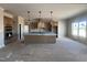 Spacious kitchen features a large island, stainless steel appliances, and modern lighting fixtures at 165 Cotton Fields Ln # 25, Fuquay Varina, NC 27526