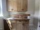 The laundry room features upper cabinets and white counters at 165 Cotton Fields Ln # 25, Fuquay Varina, NC 27526