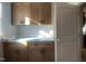 Well-designed laundry room offers built-in cabinets for extra storage at 165 Cotton Fields Ln # 25, Fuquay Varina, NC 27526
