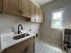 Charming laundry room with sink and patterned tile floor at 165 Cotton Fields Ln # 25, Fuquay Varina, NC 27526