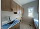 Practical laundry room featuring functional cabinets and a window at 165 Cotton Fields Ln # 25, Fuquay Varina, NC 27526