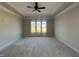 Spacious living room with hardwood floors, tray ceilings, and natural light from the large window at 165 Cotton Fields Ln # 25, Fuquay Varina, NC 27526