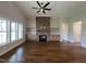 Bright and airy living room features a stone fireplace and large windows offering scenic views at 165 Cotton Fields Ln # 25, Fuquay Varina, NC 27526