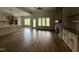 Open-concept living room with hardwood floors, a stone fireplace, and large windows at 165 Cotton Fields Ln # 25, Fuquay Varina, NC 27526