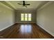 Spacious living room featuring hardwood floors, large windows, and a modern ceiling fan at 165 Cotton Fields Ln # 25, Fuquay Varina, NC 27526