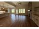 Spacious living room with hardwood floors, stone fireplace, and abundant natural light at 165 Cotton Fields Ln # 25, Fuquay Varina, NC 27526