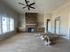 Living room with a stone fireplace, built in shelving and natural light from windows at 165 Cotton Fields Ln # 25, Fuquay Varina, NC 27526