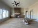 Bright living room with stone fireplace, hardwood floors, custom built-ins, and large windows at 165 Cotton Fields Ln # 25, Fuquay Varina, NC 27526