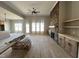 Living room with a stone fireplace, built in shelving and natural light from multiple windows at 165 Cotton Fields Ln # 25, Fuquay Varina, NC 27526