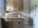 Functional mud room with countertop and overhead cabinets, offering space and organization near the entry at 165 Cotton Fields Ln # 25, Fuquay Varina, NC 27526