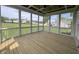 Screened porch with wood flooring, a coffered ceiling, and views of the surrounding landscape at 165 Cotton Fields Ln # 25, Fuquay Varina, NC 27526
