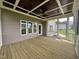 Covered back porch with wood floors and a coffered ceiling offering outdoor living space at 165 Cotton Fields Ln # 25, Fuquay Varina, NC 27526