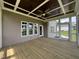 Covered porch with wood floors, ceiling fan, wood ceiling, and view of the backyard at 165 Cotton Fields Ln # 25, Fuquay Varina, NC 27526