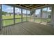 Screened porch with wood flooring and views of the backyard at 165 Cotton Fields Ln # 25, Fuquay Varina, NC 27526