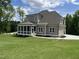 Attractive exterior elevation with a screened-in porch, backyard and lush green lawn at 165 Cotton Fields Ln # 25, Fuquay Varina, NC 27526