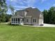 Attractive home showcasing a spacious lawn, screened porch, and attached garage at 165 Cotton Fields Ln # 25, Fuquay Varina, NC 27526