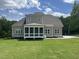 An attractive exterior elevation with a screened-in porch and lush green lawn at 165 Cotton Fields Ln # 25, Fuquay Varina, NC 27526
