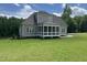 An attractive exterior elevation with a screened-in porch and lush green lawn at 165 Cotton Fields Ln # 25, Fuquay Varina, NC 27526