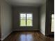 Bright, airy room featuring a large window with views of the backyard and outdoor living space at 165 Cotton Fields Ln # 25, Fuquay Varina, NC 27526
