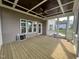 Spacious screened porch with ceiling fan, wood floors, and back door, perfect for outdoor relaxation and entertaining at 165 Cotton Fields Ln # 25, Fuquay Varina, NC 27526