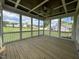 A beautiful screened-in porch with a wooden ceiling, ceiling fan, and a view of the yard at 165 Cotton Fields Ln # 25, Fuquay Varina, NC 27526