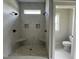 Walk-in shower with dual shower heads, pebble floor, shower bench and white tile at 165 Cotton Fields Ln # 25, Fuquay Varina, NC 27526