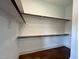 Bright walk-in closet includes wood flooring and shelving for optimal storage at 165 Cotton Fields Ln # 25, Fuquay Varina, NC 27526