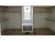 Bright walk-in closet with wooden floors, window bench, and ample shelving and hanging space at 165 Cotton Fields Ln # 25, Fuquay Varina, NC 27526