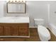 Simple bathroom features tile floors, wood vanity, toilet, and shower with tub at 204 Colonial Dr, Clayton, NC 27527