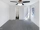 Bright bedroom with a large window, ceiling fan, gray carpet, and white trim throughout at 204 Colonial Dr, Clayton, NC 27527