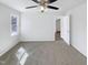 Bright bedroom with neutral carpet, white walls, ceiling fan, and natural light at 204 Colonial Dr, Clayton, NC 27527