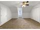 Spacious bedroom features carpet flooring, a ceiling fan, and natural light, creating a warm and inviting atmosphere at 204 Colonial Dr, Clayton, NC 27527