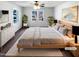 Cozy staged bedroom with neutral decor, bright windows, ceiling fan and modern furnishings at 204 Colonial Dr, Clayton, NC 27527