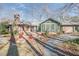 Brick home exterior with a cozy patio, chimney, and a well-maintained lawn and gravel at 221 Saddle Ridge Rd, Chapel Hill, NC 27514