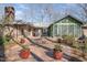 Brick patio area featuring outdoor seating, potted plants, and a glimpse of the home's exterior at 221 Saddle Ridge Rd, Chapel Hill, NC 27514