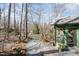 Backyard featuring a screened in porch, mature trees, and a peaceful gravel path at 221 Saddle Ridge Rd, Chapel Hill, NC 27514