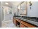 Bathroom with wood cabinets, granite countertops, and an enclosed tub and shower at 221 Saddle Ridge Rd, Chapel Hill, NC 27514