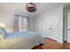 Bedroom with hardwood floors, white trim, and a ceiling fan with light fixture at 221 Saddle Ridge Rd, Chapel Hill, NC 27514
