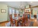 Formal dining room featuring a fireplace, hardwood floors, and large windows at 221 Saddle Ridge Rd, Chapel Hill, NC 27514