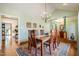Inviting dining room featuring a wooden table, elegant chandelier, and views into the living room at 221 Saddle Ridge Rd, Chapel Hill, NC 27514