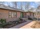 Close-up of a well-maintained brick home with a bright green front door and neatly landscaped walkway at 221 Saddle Ridge Rd, Chapel Hill, NC 27514