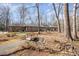 Stunning single-story brick home with beautiful landscaping and a charming bridge feature at 221 Saddle Ridge Rd, Chapel Hill, NC 27514