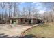 Sprawling single-story brick house featuring a green garage door and manicured lawn at 221 Saddle Ridge Rd, Chapel Hill, NC 27514