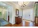Elegant foyer features hardwood floors, chandelier, and decorative mirror at 221 Saddle Ridge Rd, Chapel Hill, NC 27514