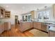 Well-appointed kitchen featuring light wood cabinets, stainless appliances, and an adjacent eating area at 221 Saddle Ridge Rd, Chapel Hill, NC 27514