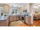 Charming kitchen with stainless steel appliances, light wood cabinets, and lots of natural light at 221 Saddle Ridge Rd, Chapel Hill, NC 27514